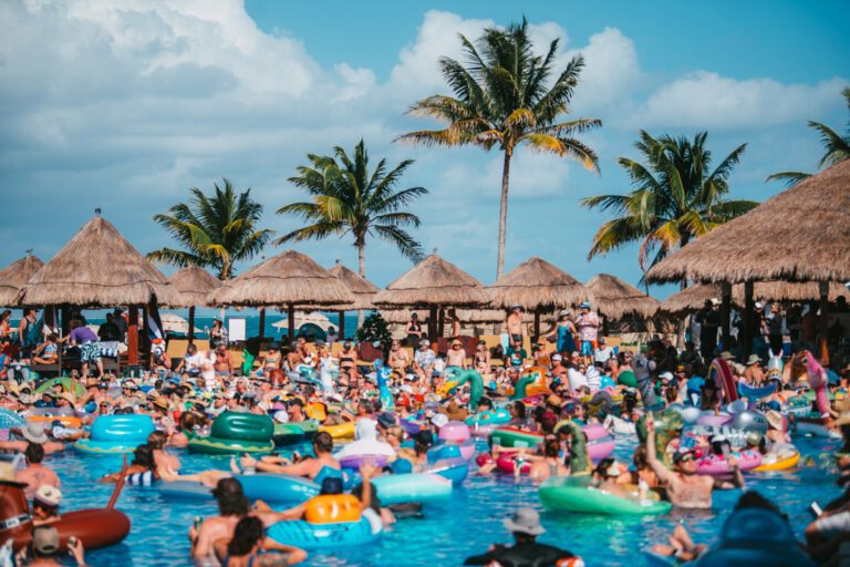 A crowd of people in pool floats.