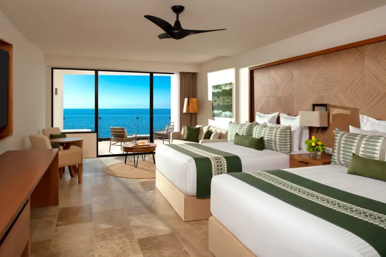 A double bed room with an ocean view balcony.