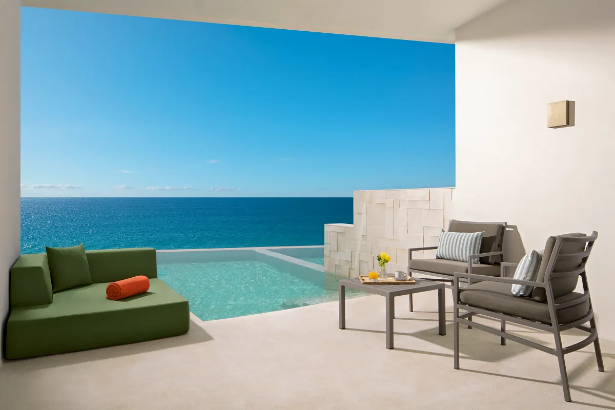 A close up of the patio of a swim-up pool suite with an ocean view.