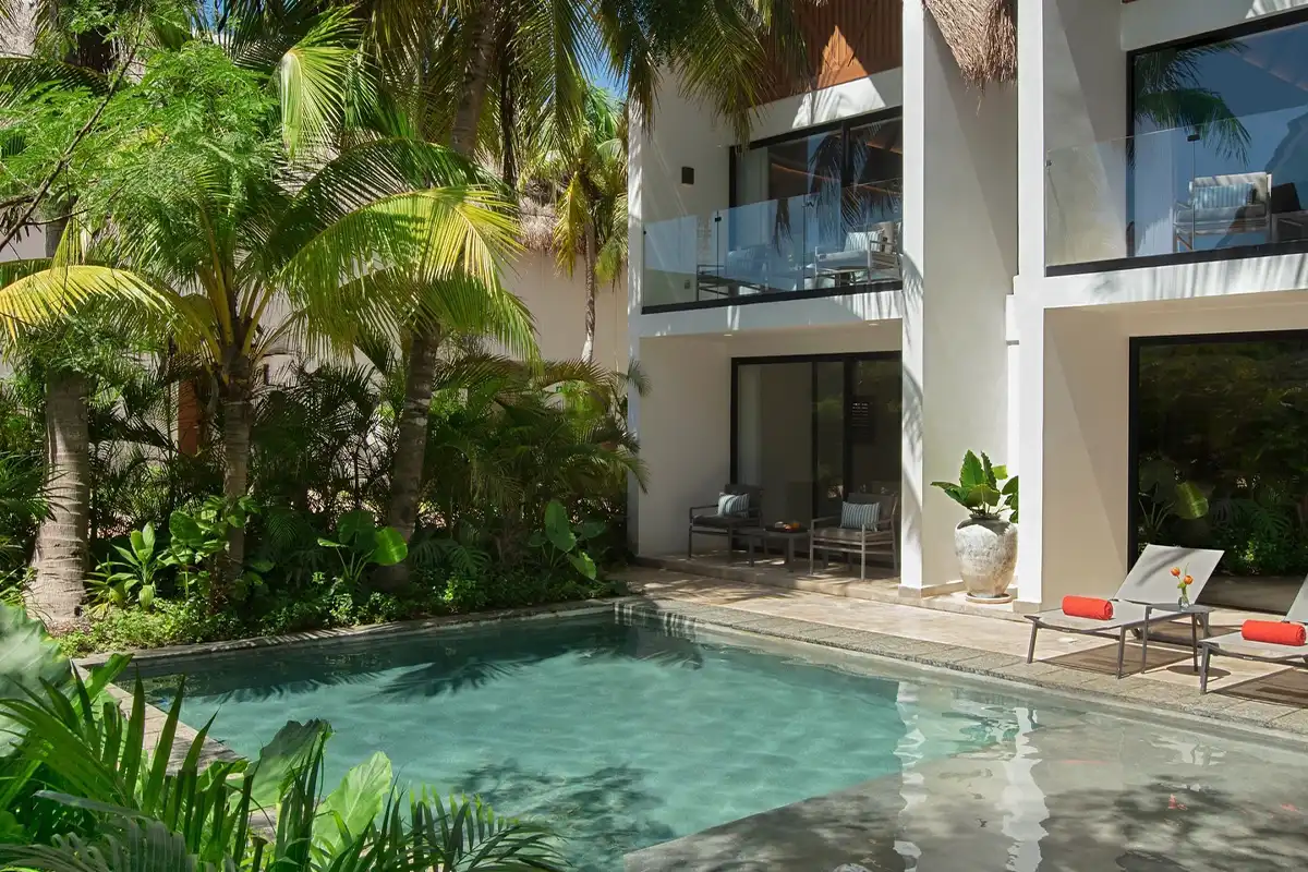 Private pool and patio area of a two-story villa suite.
