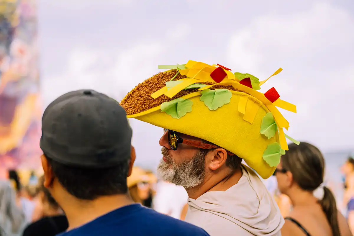 A guest wearing a taco hat for a theme night.