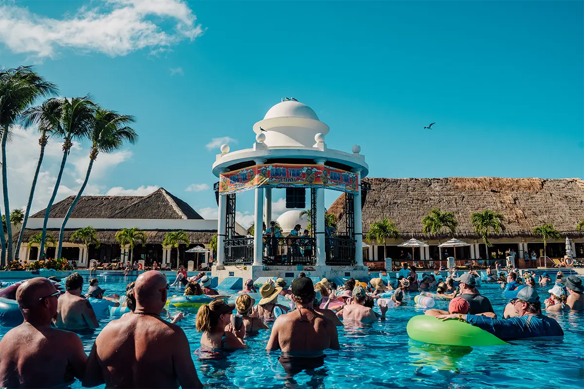 The Poolside Gazebo stage with fans floating in the pool around it.