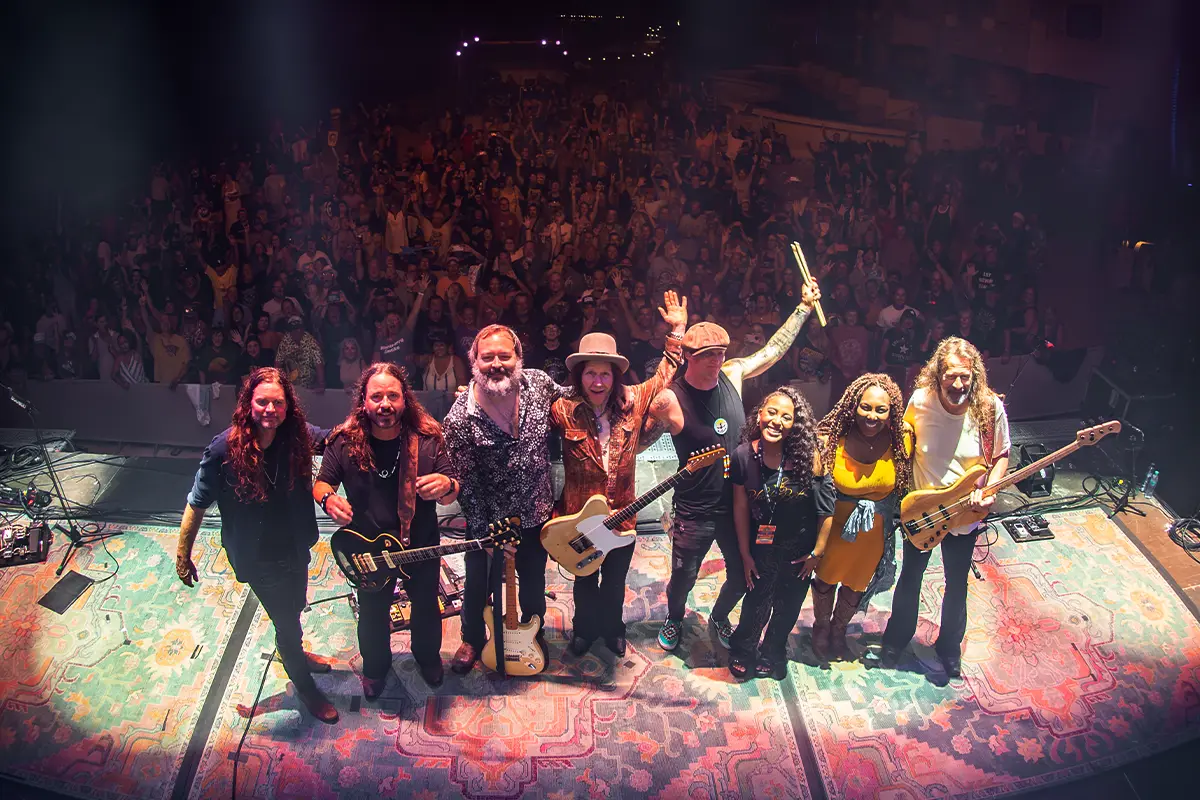 A group photo of Blackberry Smoke posing with the crowd behind them.
