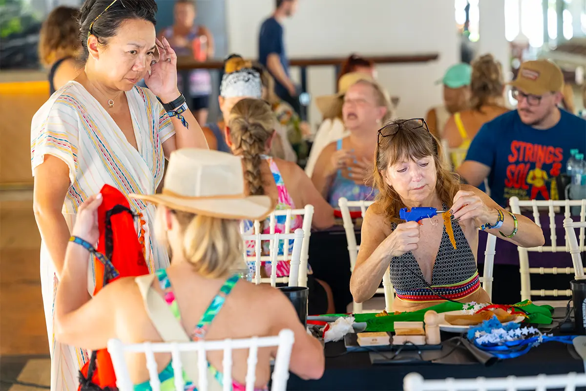Guests sitting at a table participating in a crafting activity.